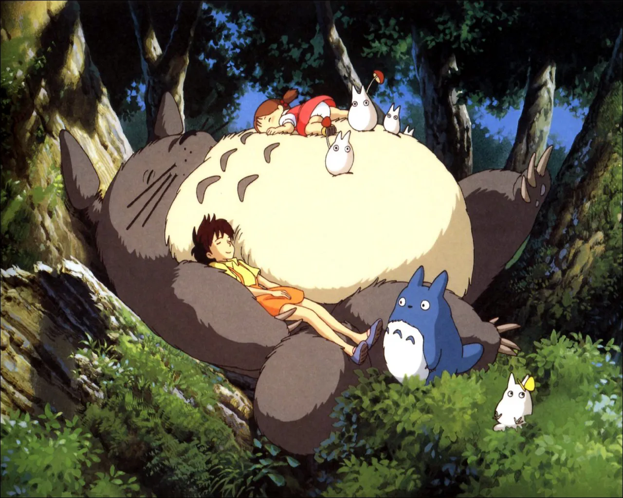 Man sieht eine Szene aus „Mein Nachbar Totoro“, der große flauschige Waldgeist liegun unter einem Baum, die Schwetern in seinem Arm, bzw. auf seinem Bauch. Der Film gab dem Totoro-Wald seinen Spitznamen.